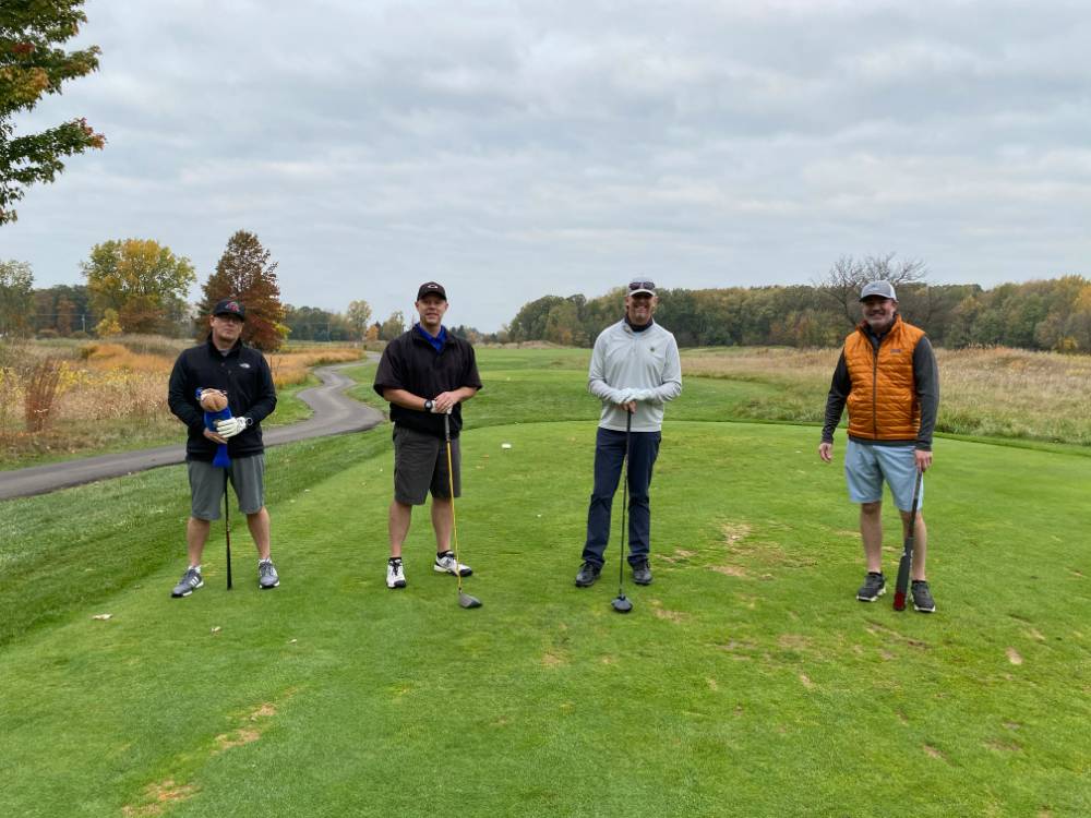 Four alumni together on golf course